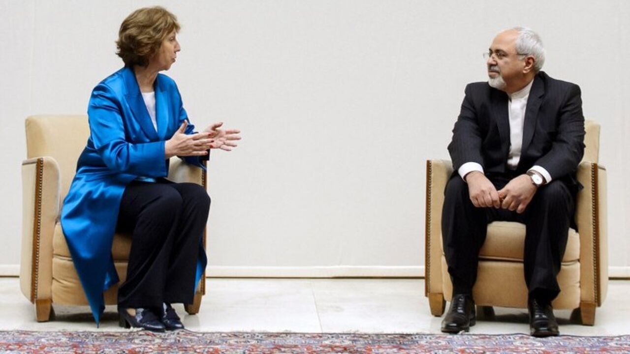 European Union foreign policy chief Catherine Ashton (L) speaks with Iranian Foreign Minister Mohammad Javad Zarif during a photo opportunity before the start of two days of closed-door nuclear talks at the United Nations offices in Geneva October 15, 2013. Iran will face pressure on Tuesday to propose scaling back its nuclear programme to win relief from crippling sanctions as talks between world powers and Tehran resume after a six-month hiatus. REUTERS/Fabrice Coffrini/Pool (SWITZERLAND - Tags: ENERGY PO