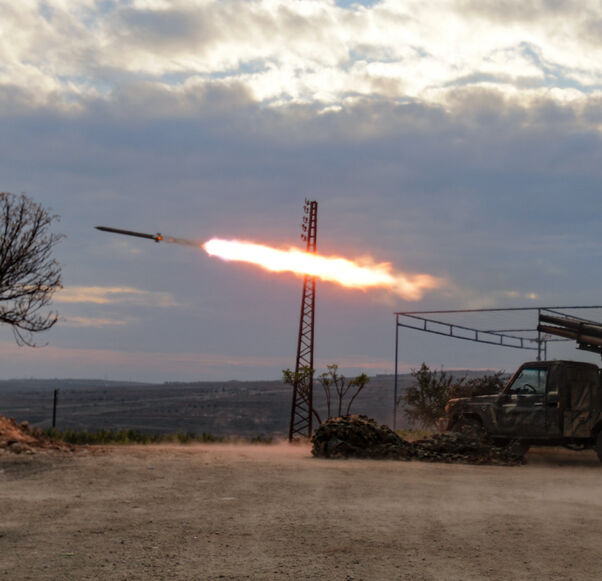 An anti-government fighter covers his ears as a multi-barrel rocket launcher fires against regime forces, in the northern outskirts of Syria's west-central city of Hama on Dec. 4, 2024.