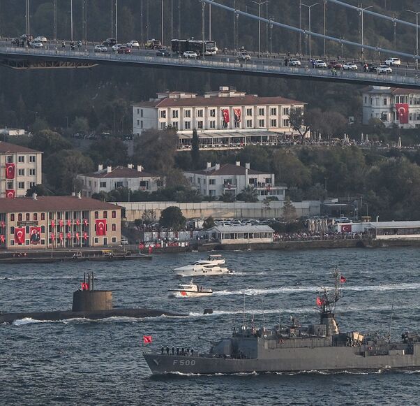 Turkish naval forces patrol vessel TCG F 500 and an unidentified submarine (back) sail during a military naval parade on the Bosphorus in Istanbul on Oct. 29, 2023.
