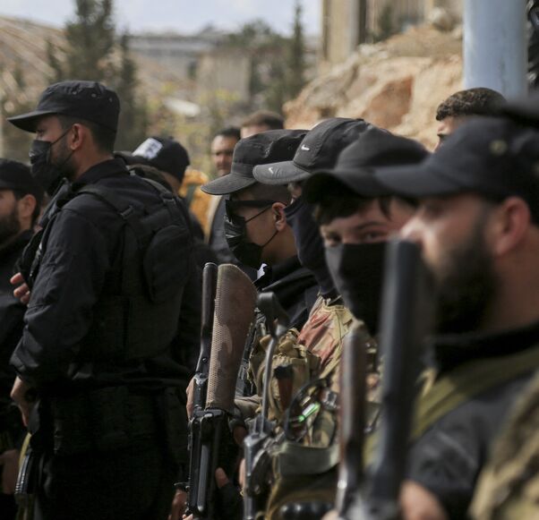 Armed personnel of SDF and public security forces of the new Syrian government stand guard in al-Ramun district of Aleppo, Syria, on April 3, 2025. 