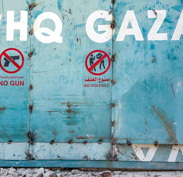 A boy sits outside the entrance to the United Nations Relief and Works Agency for Palestine Refugees (UNRWA) building complex in Gaza City, on Sept. 6, 2025.