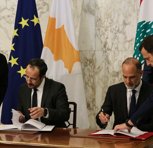 Cypriot President Nikos Christodoulides signs documents with Lebanese Minister of Public Works and Transport Fayez Rasamny, as Lebanon's president, Joseph Aoun, looks on during an agreement signing ceremony at the presidential palace of Baabda, east of Beirut, on Nov. 26, 2025. 