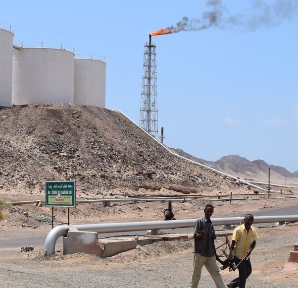 Yemeni employees walk at the Aden oil refinery company in Yemen's port city of Aden on Sept. 29, 2015.
