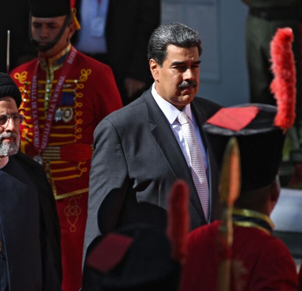 Iranian President Ebrahim Raisi (L) is welcomed by Venezuelan President Nicolas Maduro at Miraflores Presidential Palace in Caracas, on June 12, 2023. Iranian President Ebrahim Raisi arrived in Venezuela Monday for the start of a visit to "friendly countries" that also include Cuba and Nicaragua, all under sanctions from a common adversary, the United States. (Photo by Yuri CORTEZ / AFP) (Photo by YURI CORTEZ/AFP via Getty Images)
