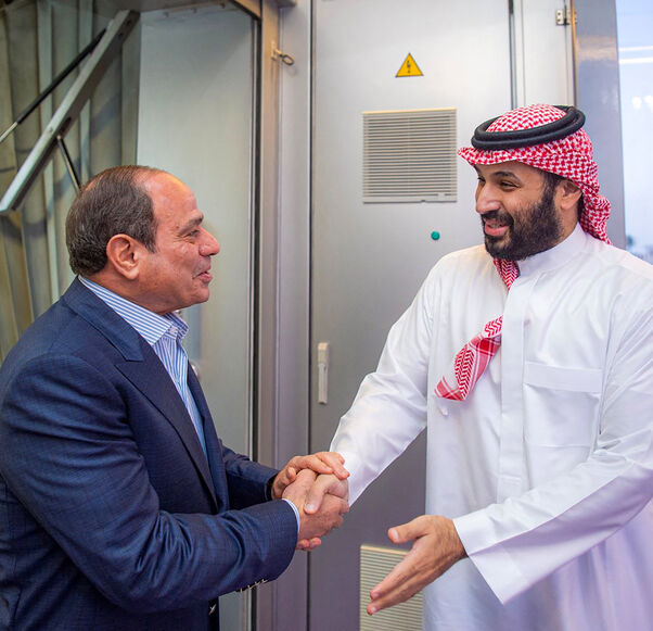 This handout picture released by the Saudi Press Agency (SPA) on February 23, 2026, shows Saudi Crown Prince Mohammed bin Salman (R) welcoming Egypt's President Abdel Fattah El-Sisi (L) upon his arrival for an official visit at King Abdulaziz International Airport in Jeddah. (Photo by Ahmed NURELDINE / SPA / AFP via Getty Images)