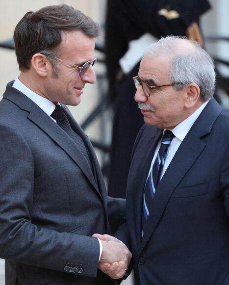 France's President Emmanuel Macron (L) wearing sunglasses shakes hands with Lebanon's Prime Minister Nawaf Salam prior to their meeting at the Elysee presidential palace in Paris, on January 23, 2026. (Photo by Ludovic MARIN / AFP via Getty Images)