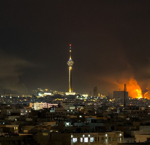 Smoke and flames rise at the site of airstrikes on an oil depot in Tehran on March 7, 2026. 