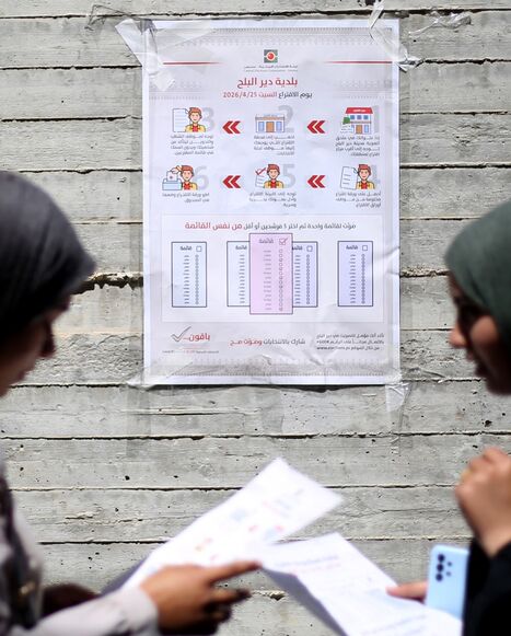 Women read instructions to voters ahead of the upcoming municipal elections in Deir el-Balah in the central Gaza Strip on April 21, 2026. 
