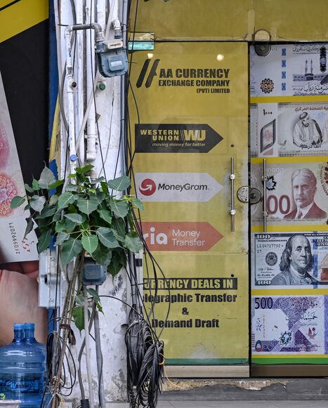 A security personnel sits in a market after markets reopened in Islamabad on April 23, 2026, following heightened security measures amid the ongoing US-Iran peace talks.