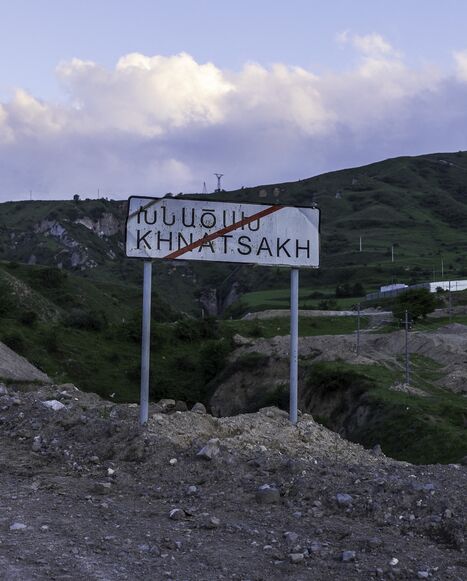 A roadside sign marks the entrance to Khnatsakh on May 16, 2025, a border village in Armenia's Syunik Province that has become a frontline community amid rising tensions with Azerbaijan. 