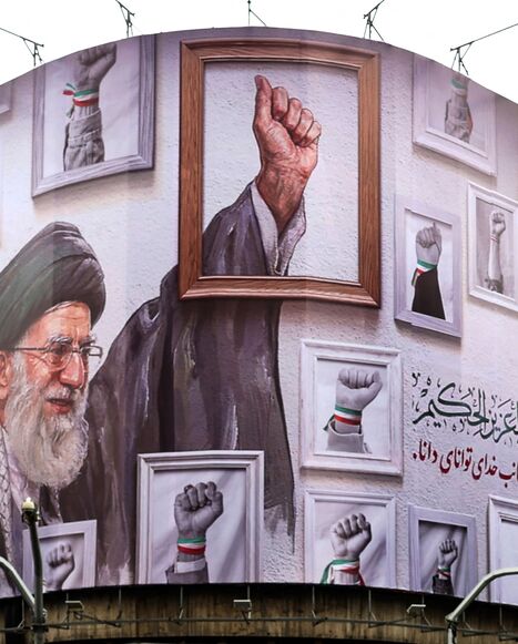 A billboard with the image of the late Iranian supreme leader Ayatollah Ali Khamenei wraps the front of a building in Tehran on May 5, 2026. 