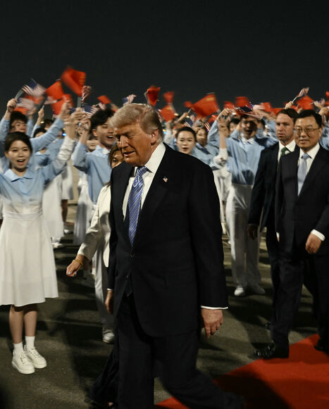 TOPSHOT - US President Donald Trump (C) is escorted by China's Vice President Han Zheng (R) upon his arrival at Beijing Capital Airport in Beijing on May 13, 2026. (Photo by Brendan SMIALOWSKI / AFP via Getty Images)
