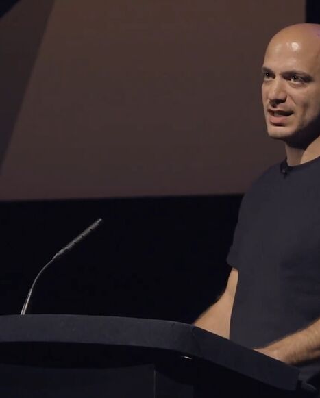  Hassan Akkad speaks about fleeing Syria in 2015 and his work as a filmmaker at a BAFTA event, Sept. 2023.