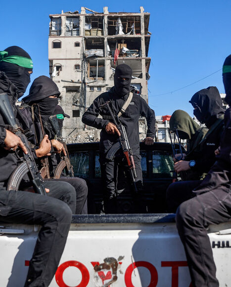 Palestinian Hamas militants arrive to secure the area as Egyptian workers accompanied by members of the International Committee of the Red Cross (ICRC), search for the last two remaining bodies of hostages -an Israeli soldier and a Thai national- from under the rubble of the Jabalia refugee camp, in the northern of Gaza Strip on Dec. 1, 2025.