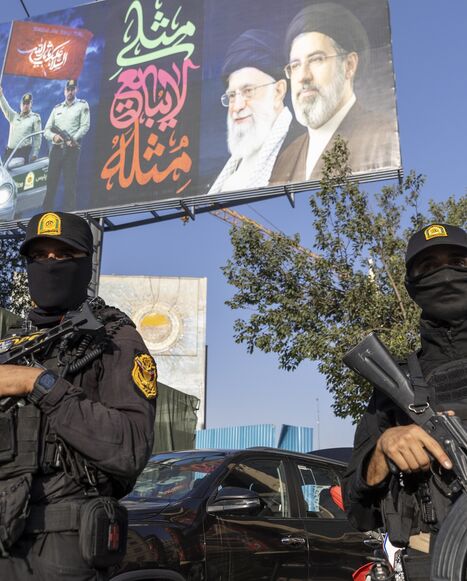 Iranian NOPO special police officers stand guard in front of a large portrait of Iran's late Supreme Leader, Ayatollah Ali Khamenei, at Valiasr square on July 3, 2026, in Tehran, Iran. 