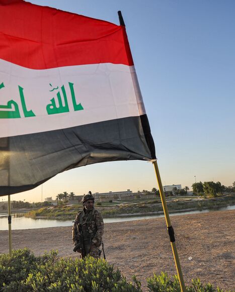 Members of Iraq's Hashed al-Shaabi (Popular Mobilization) paramilitary forces stand guard during an election rally for the "Asaib Ahl al-Haq" movement in the capital Baghdad, on October 7, 2021. 
