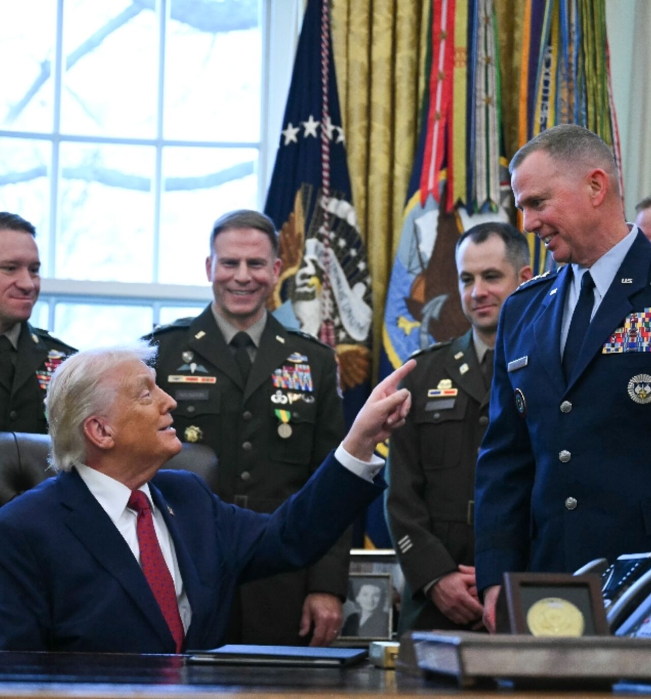 US President Donald Trump speaks with military officers at the White House