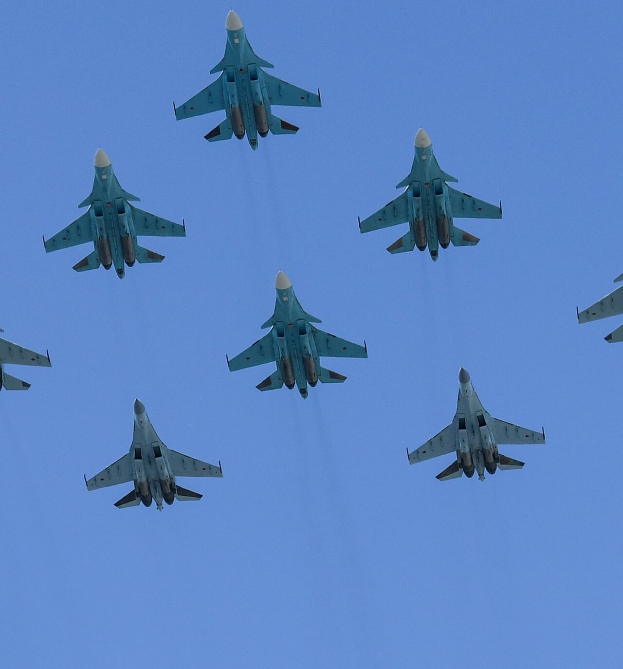 Russian Sukhoi Su-35S fighter aircrafts, Su-34 military fighter jets and Su-30SM jet fighters fly over downtown Moscow during a military parade on June 24, 2020. 