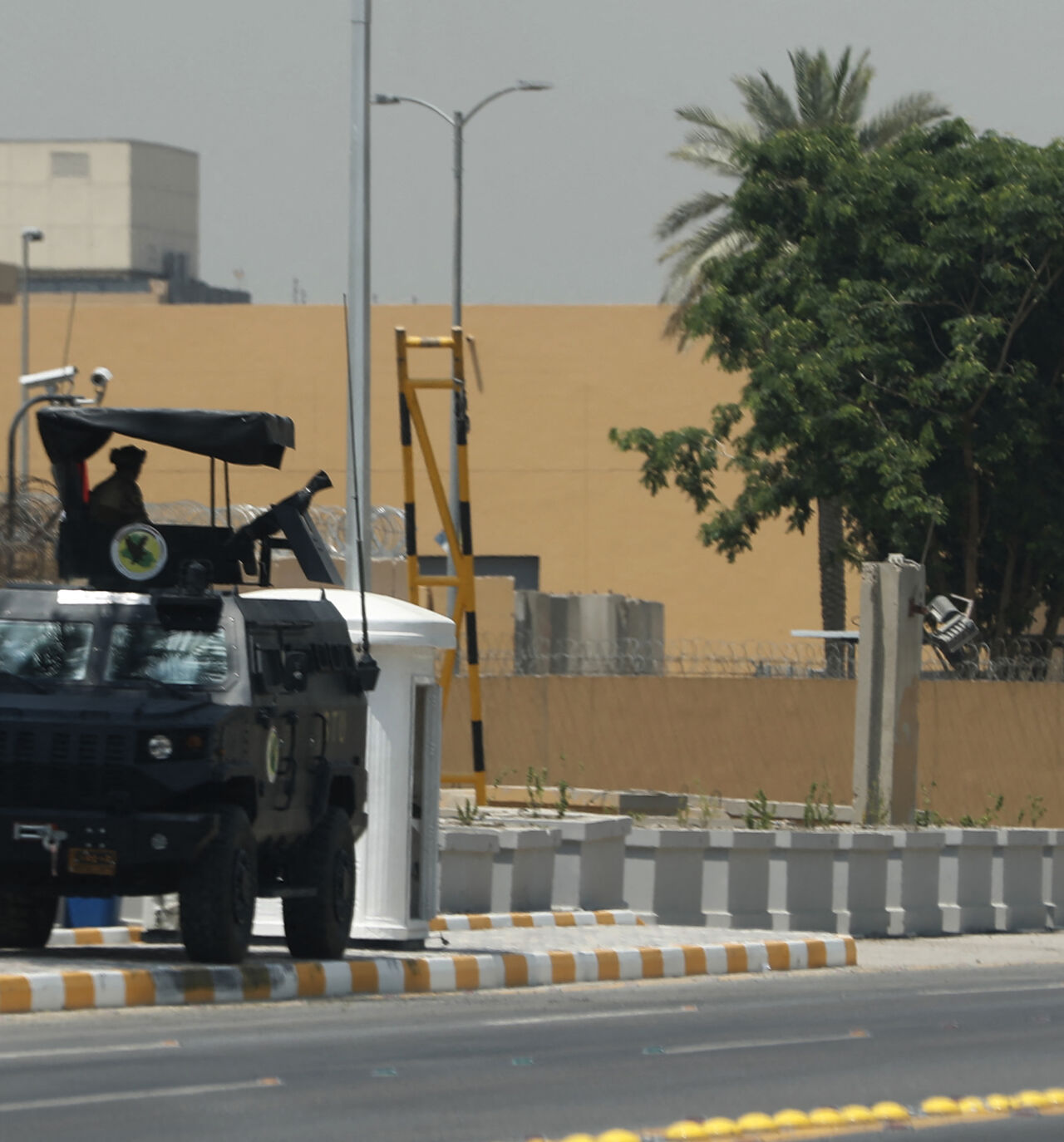 Armoured vehicles of the Iraqi Counter Terrorism Forces are deployed outside the US embassy building in Baghdad's Green Zone on June 12, 2025, after an announcement by a US official the previous day that staff levels at the diplomatic mission in Iraq were being reduced over security concerns. Despite reporting progress in earlier rounds of talks between Iran and the United States, tensions have reached a fever pitch this week as Washington moved non-essential staff from bases in the region following US medi