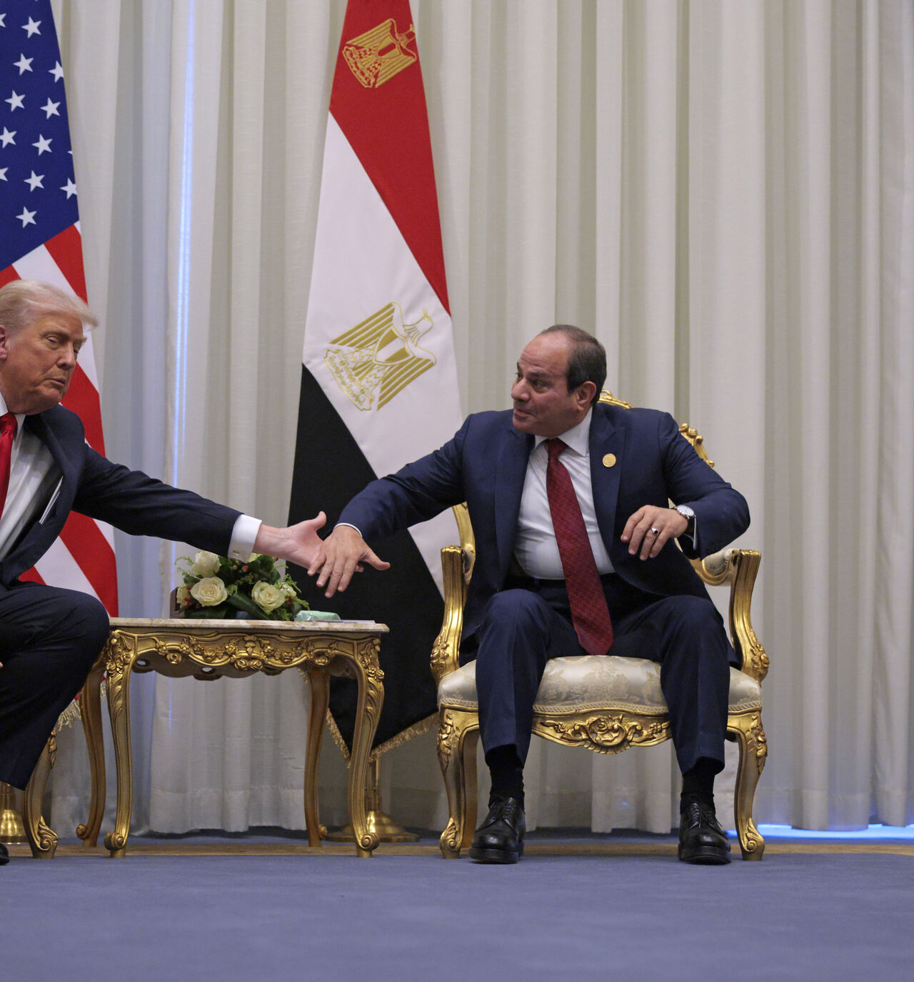 SHARM EL-SHEIKH, EGYPT - OCTOBER 13: U.S. President Donald Trump and President of Egypt Abdel Fattah El-Sisi clasp hands as they speak to the press before their meeting on October 13, 2025 in Sharm El-Sheikh, Egypt. President Trump is in Egypt to meet with European and Middle Eastern leaders in what’s being billed as an international peace summit, following the start of a US-brokered ceasefire deal to end the war in the Gaza Strip. (Photo by Chip Somodevilla/Getty Images)