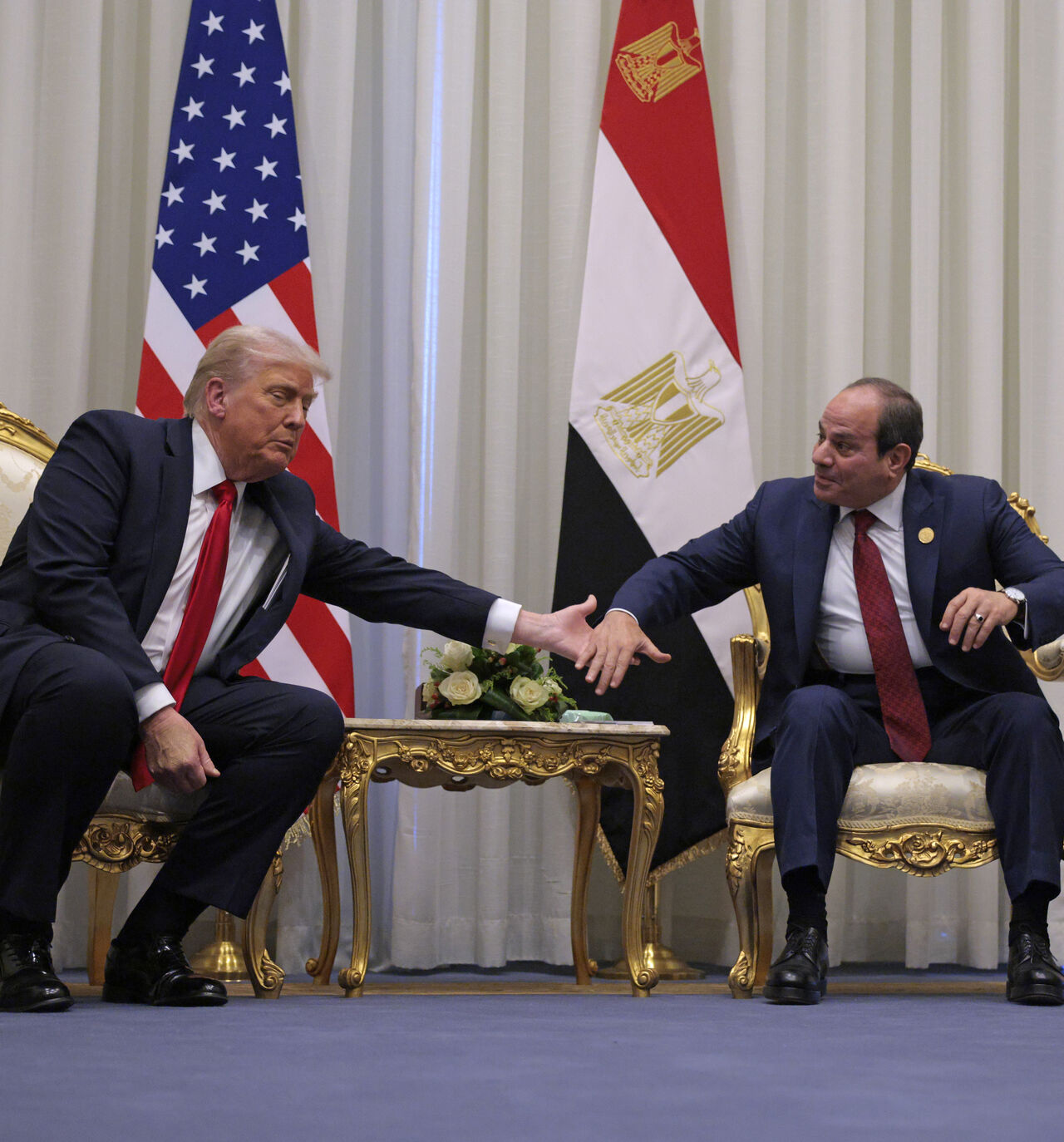 SHARM EL-SHEIKH, EGYPT - OCTOBER 13: U.S. President Donald Trump and President of Egypt Abdel Fattah El-Sisi clasp hands as they speak to the press before their meeting on October 13, 2025 in Sharm El-Sheikh, Egypt. President Trump is in Egypt to meet with European and Middle Eastern leaders in what’s being billed as an international peace summit, following the start of a US-brokered ceasefire deal to end the war in the Gaza Strip. (Photo by Chip Somodevilla/Getty Images)