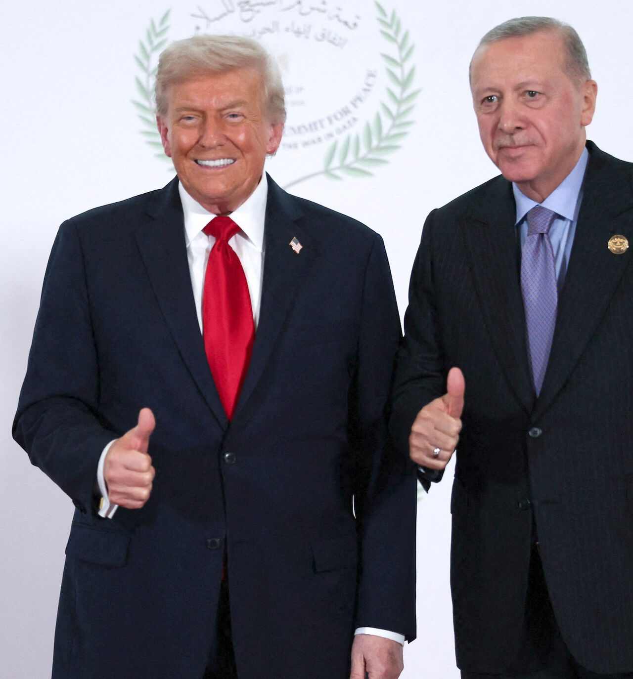 US President Donald Trump and Turkish President Tayyip Erdogan gesture as they pose for a photo during a world leaders' summit on ending the Gaza war on Oct. 13, 2025 in Sharm El-Sheikh, Egypt. 