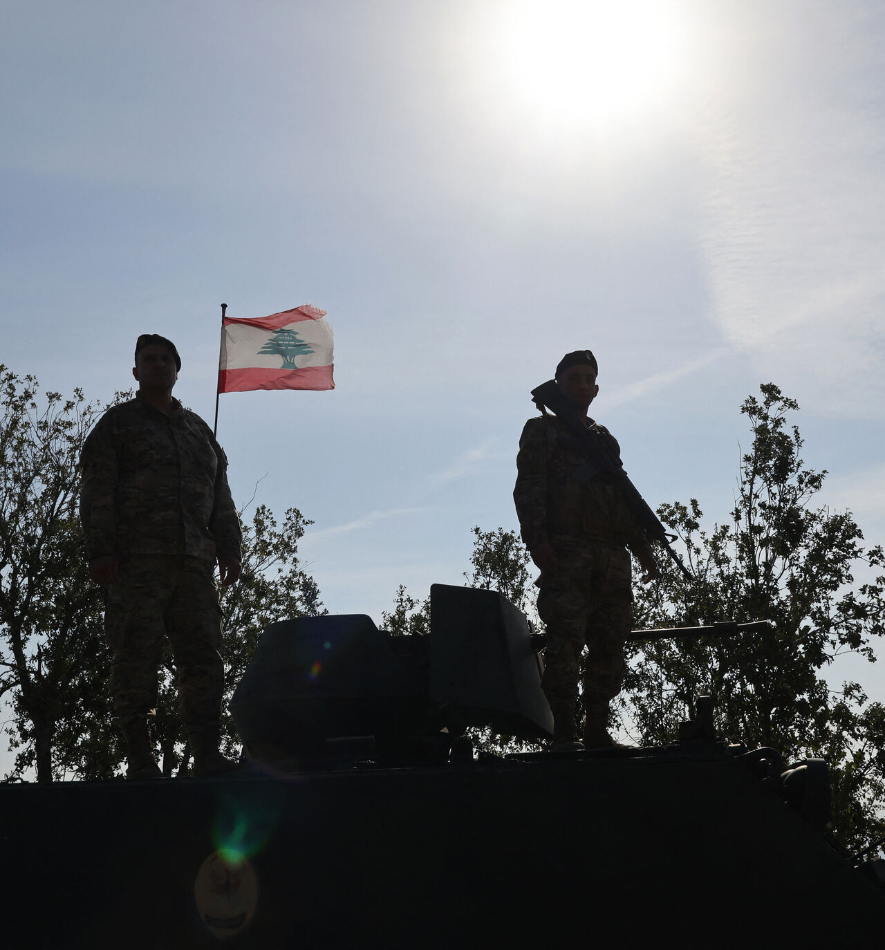 This photograph taken during a press tour organised by the Lebanese army shows Lebanese soldiers standing atop a military vehicle in Alma Al-Shaab, near the border with Israel in southern Lebanon, on November 28, 2025. It was the first guided tour the army gave journalists since a November 2024 ceasefire sought to end over a year of hostilities between Hezbollah and Israel. (Photo by Anwar AMRO / AFP via Getty Images)
