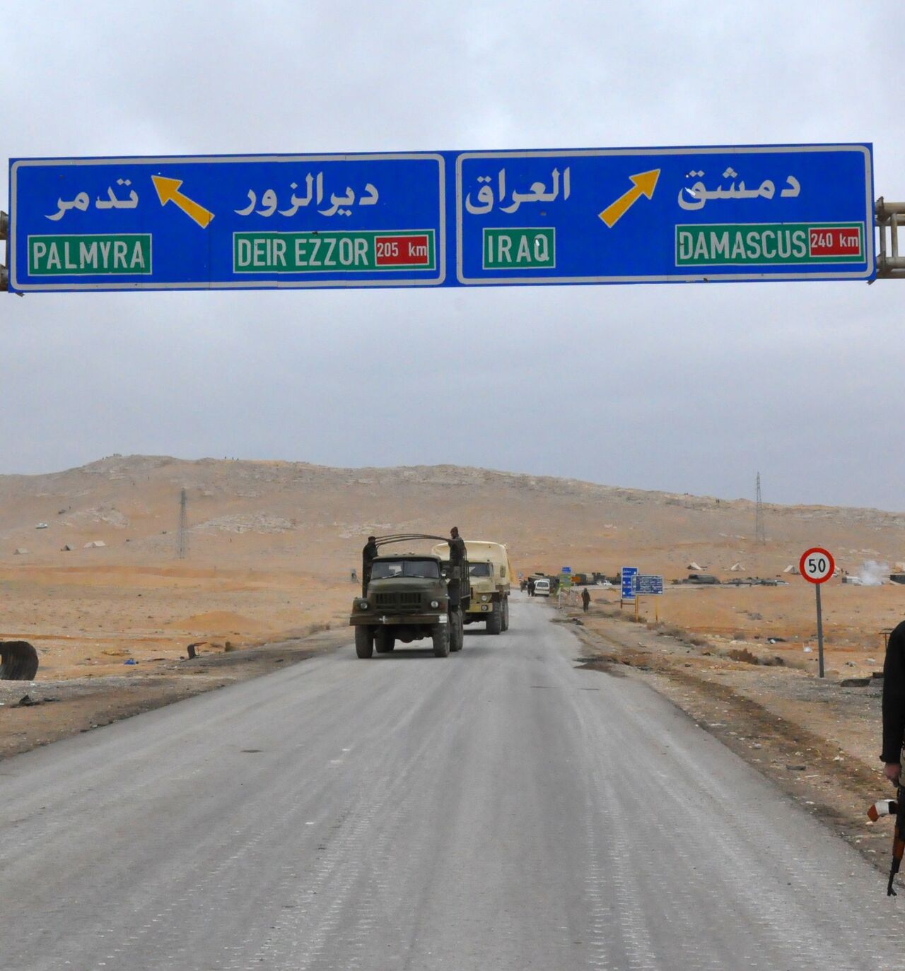 A picture taken on March 2, 2017, shows a sign displaying the routes to Palmyra-Deir Ezzor and Damascus-Iraq as Syrian regime fighters advance to retake the ancient city of Palmyra, from Islamic State (IS) group fighters. / AFP PHOTO / STRINGER (Photo credit should read STRINGER/AFP via Getty Images)