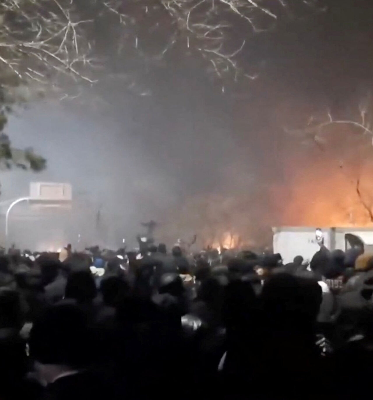 Smoke rises as protesters gather amid evolving anti-government unrest at Vakilabad highway in Mashhad, Razavi Khorasan province, Iran, released on January 10, 2026, in this screen grab obtained from a social media video. SOCIAL MEDIA/via REUTERS