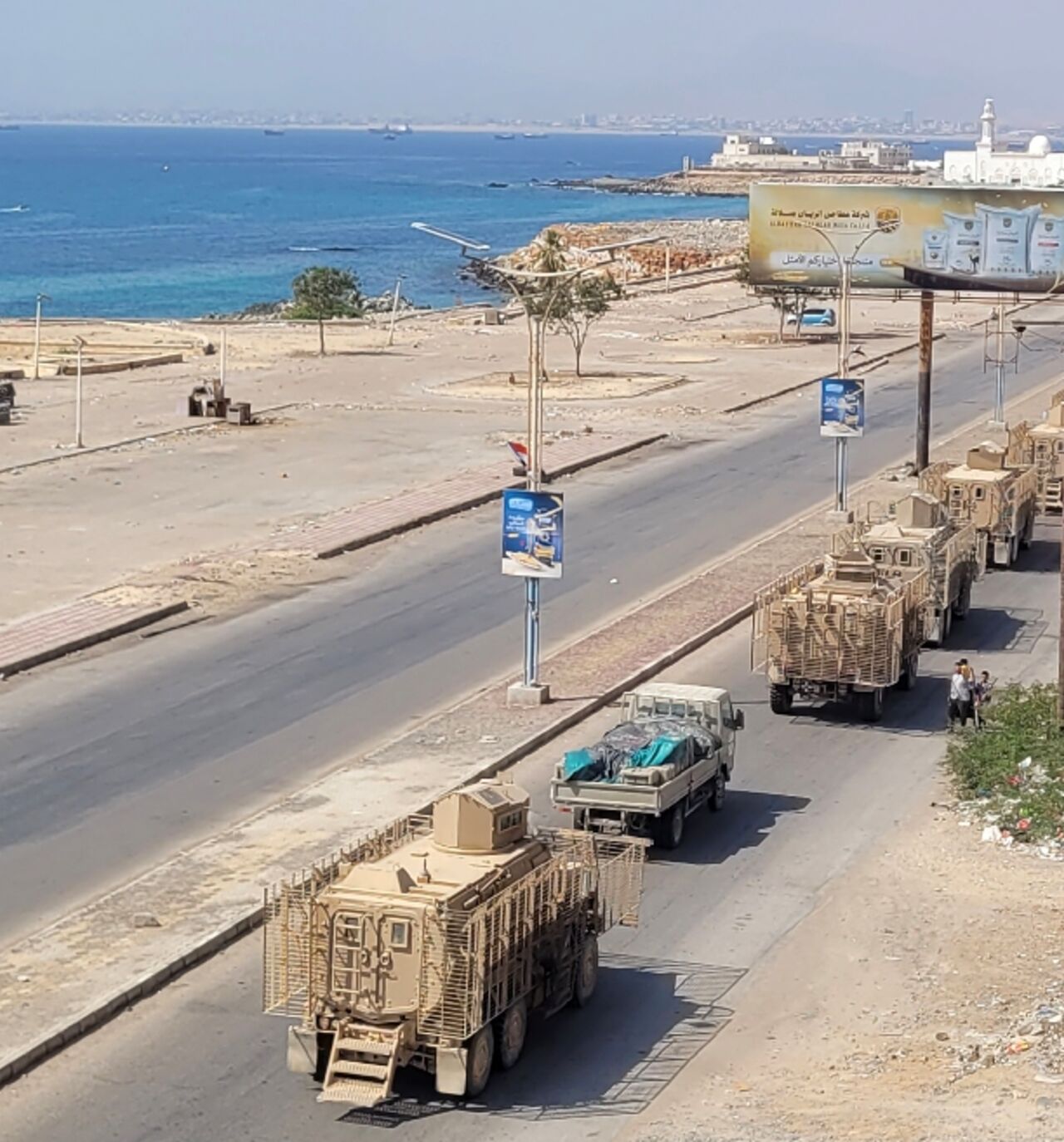 A convoy of armoured vehicles makes its way along a street in southern Yemen on January 1