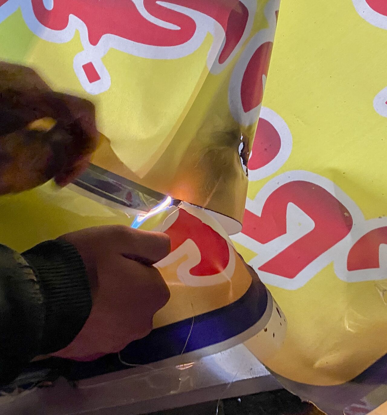 A person uses a lighter to set fire to a banner during demonstrations in Hamedan, Iran, on Jan. 1, 2026. 