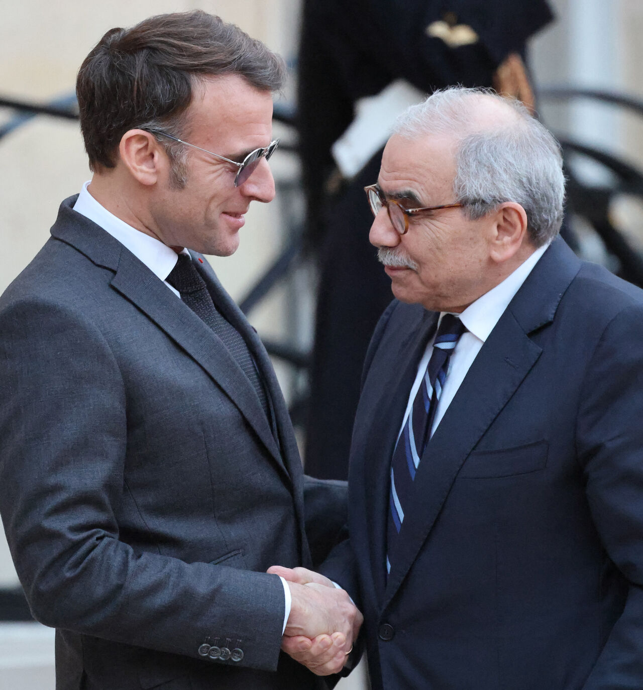France's President Emmanuel Macron (L) wearing sunglasses shakes hands with Lebanon's Prime Minister Nawaf Salam prior to their meeting at the Elysee presidential palace in Paris, on January 23, 2026. (Photo by Ludovic MARIN / AFP via Getty Images)