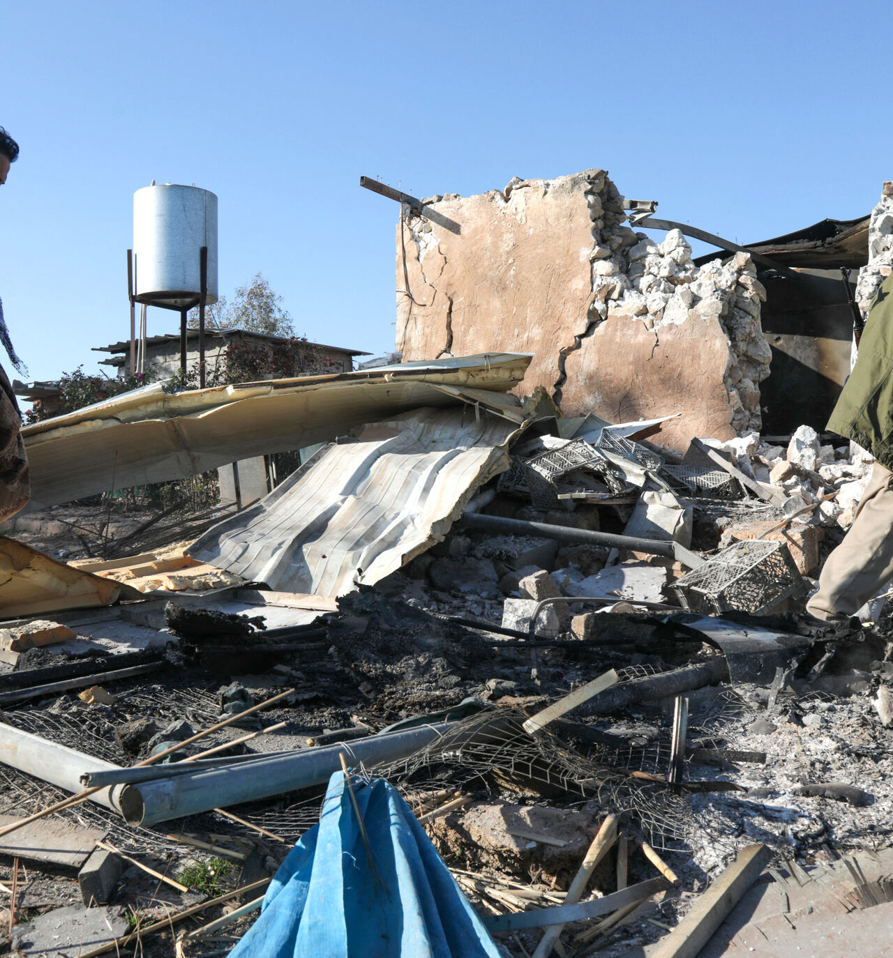 An Iranian Kurdish Peshmerga member of the Kurdistan Democratic Party of Iran (KDPI) inspects damage sustained at the Azadi Camp of the Kurdistan Democratic Party of Iran (KDPI) following an Iranian cross-border attack in the town of Koye (Koysinjaq), in the east of Erbil district in the autonomous Kurdish region of northern Iraq on March 3, 2026. The United States and Israel launched strikes against Iran on February 28, with the killing of Iran's supreme leader and the Islamic republic retaliated with barr