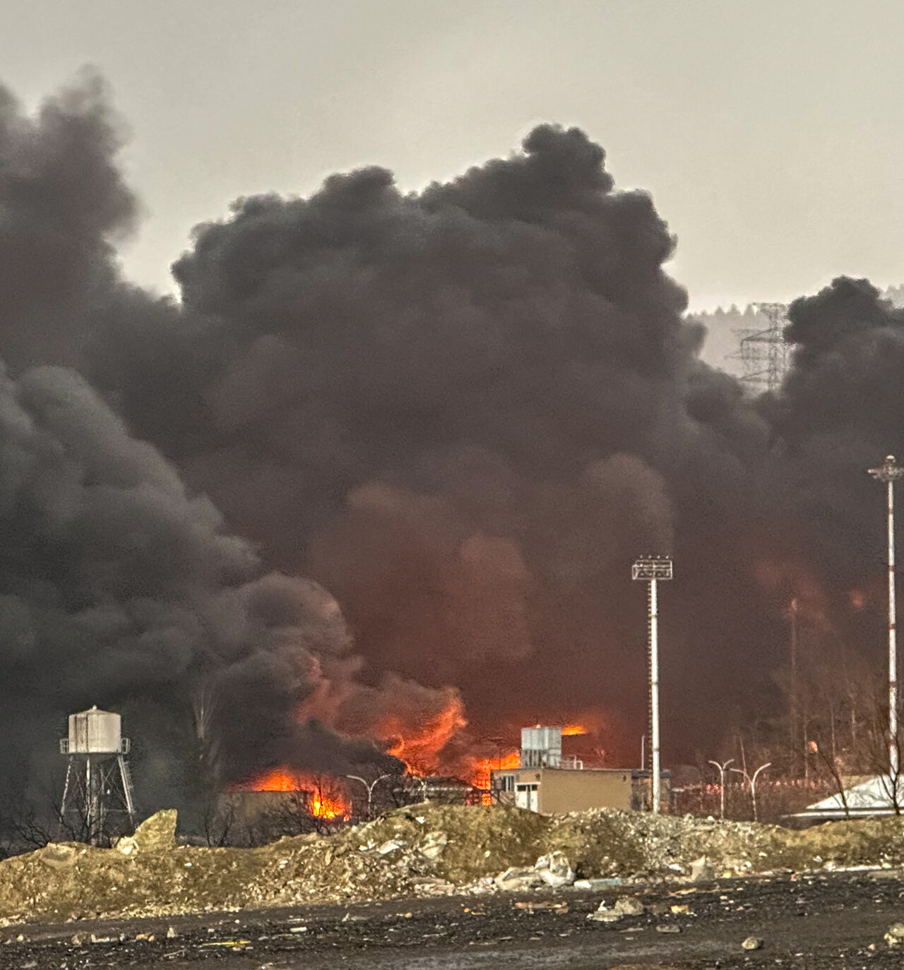 Smoke and flames rise at the site of airstrikes on an oil depot, Tehran, Iran, March 8, 2026.