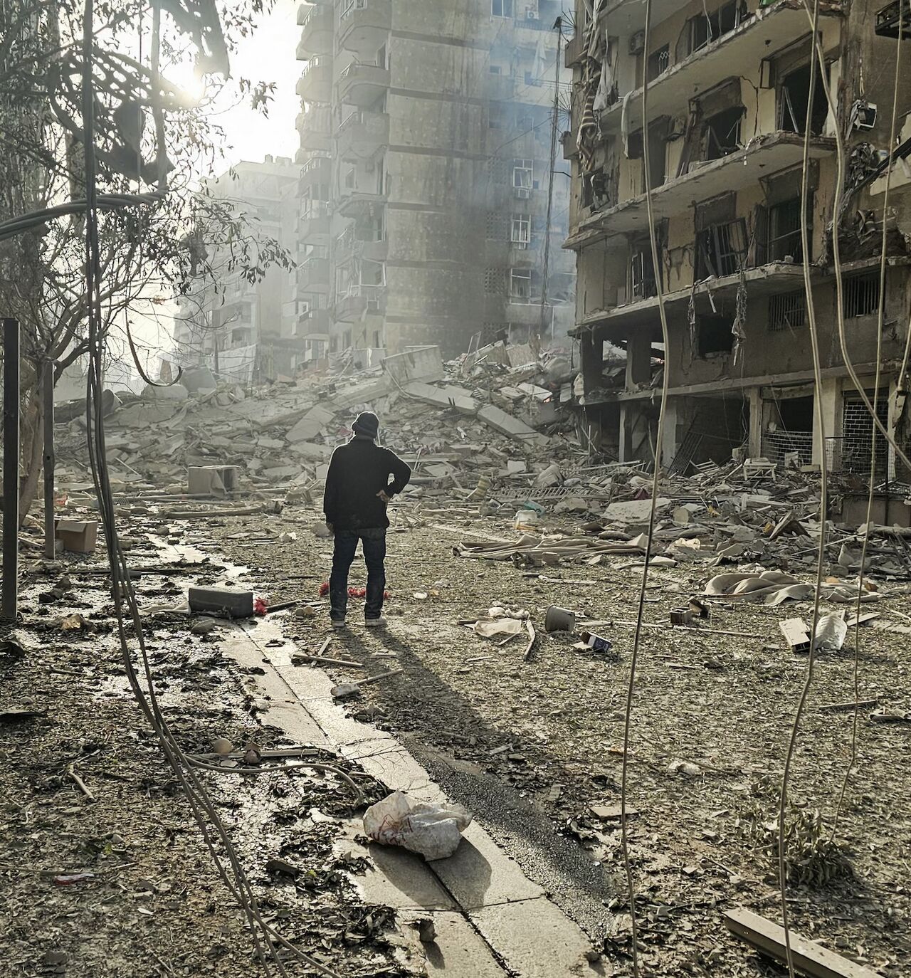 A man looks at the site of overnight Israeli airstrikes in the southern suburbs of Beirut on March 12, 2026. 
