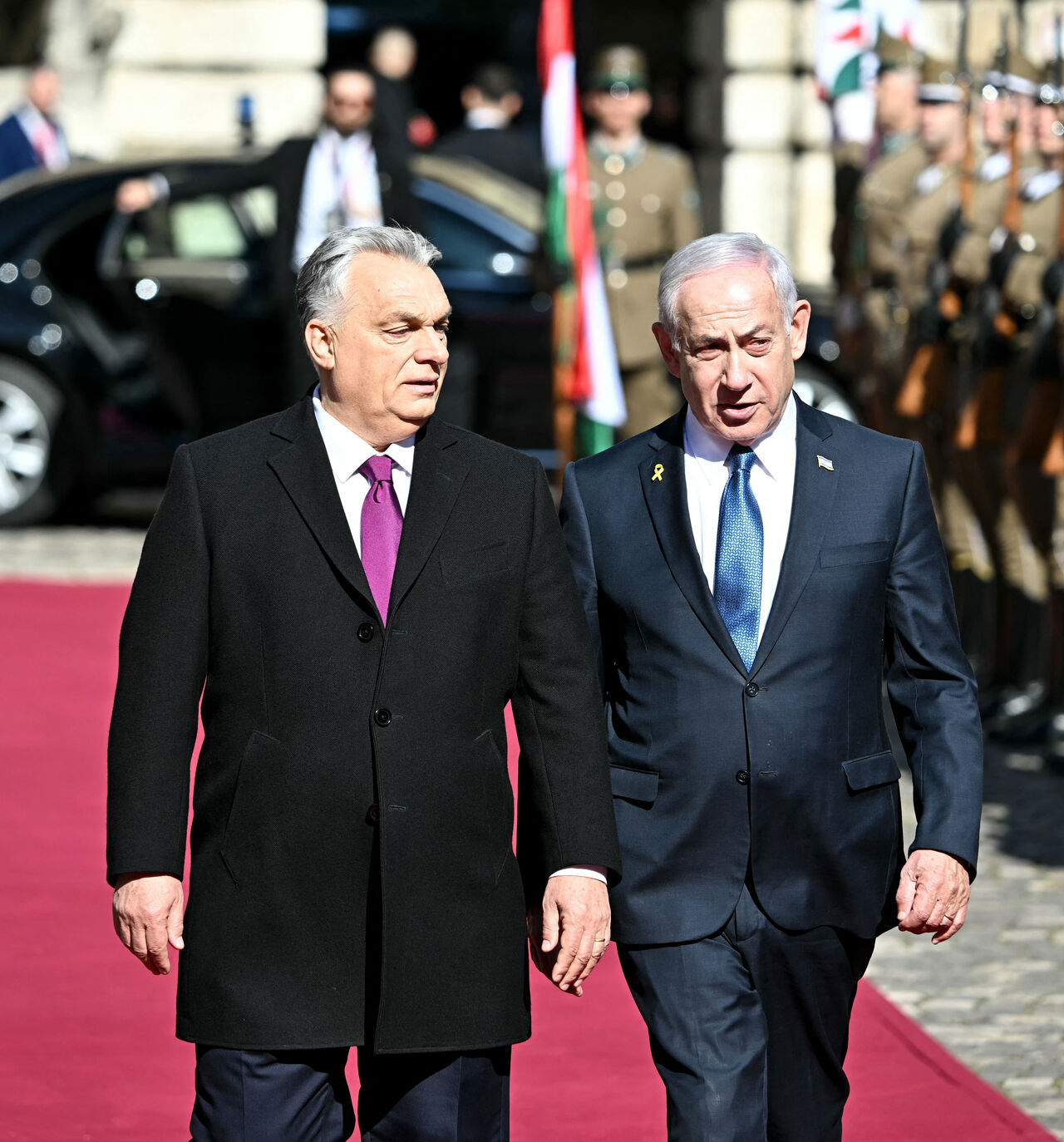 Hungary's Prime Minister Viktor Orban (L) and Israeli Prime Minister Benjamin Netanyahu review a military honor guard on April 3, 2025 in Budapest, Hungary. Israeli Prime Minister Benjamin Netanyahu arrived in Hungary in defiance of the International Criminal Court (ICC)'s arrest warrant against him over alleged war crimes in Gaza. Hungary has long-standing ties with Israel, and they been further bolstered up since the start of the war in Gaza, sparked by the Palestinian militant group Hamas's attack on Oct