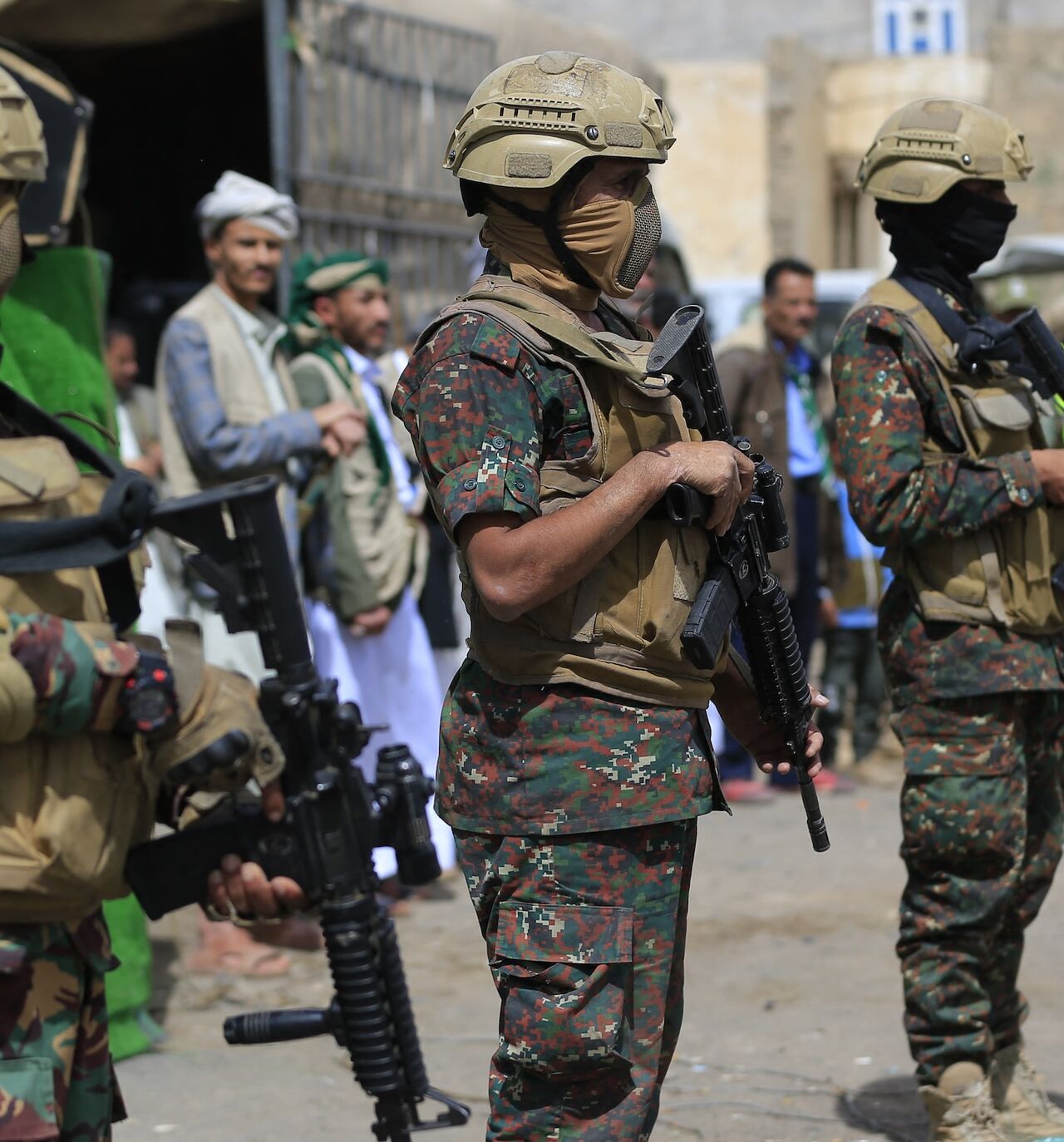 Members of Houthi security forces stand guard while supporters of Yemen's Houthi movement attend an event commemorating the ninth anniversary of the Saudi-led intervention in their country, in the capital, Sanaa, on March 26, 2026. 