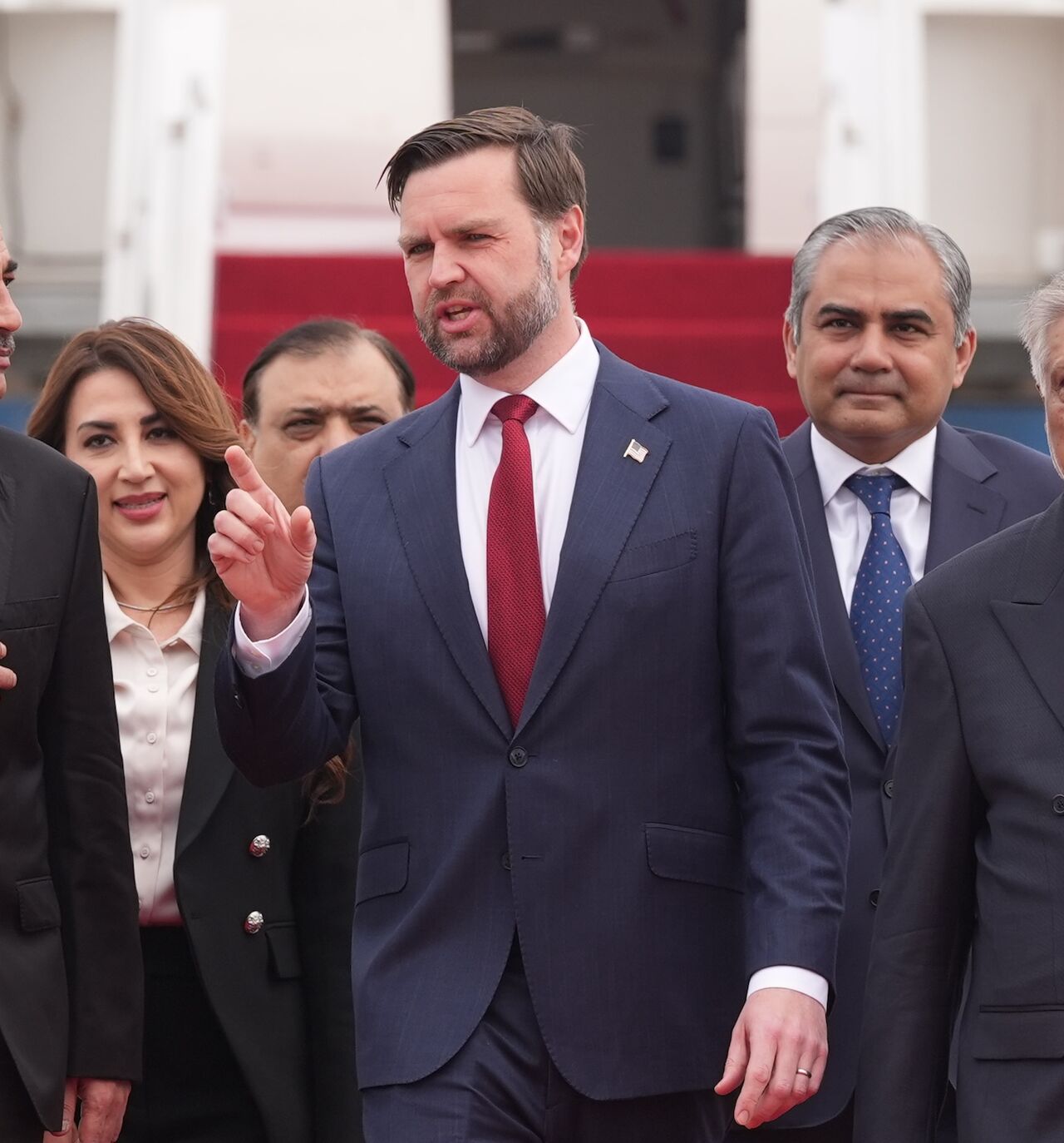 US Vice President JD Vance (C) walks with Pakistan's Chief of Defense Forces and Chief of Army Staff Field Marshall Asim Munir (L), and Pakistani Deputy Prime Minister and Foreign Minister Mohammad Ishaq Dar after arriving for talks with Iranian officials on April 11, 2026, in Islamabad, Pakistan. 