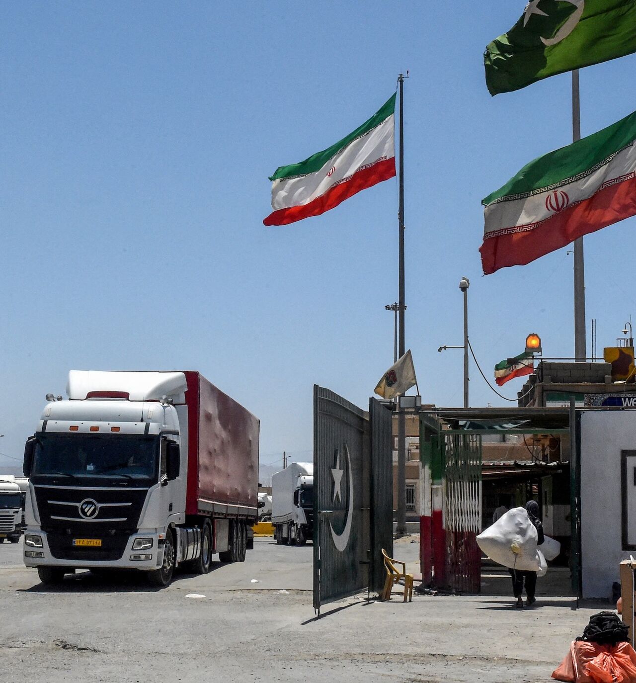 Iranian cargo trucks cross into the Pakistan-Iran border at Taftan, Balochistan province, on June 18, 2025, amid the ongoing conflict between Israel and Iran.