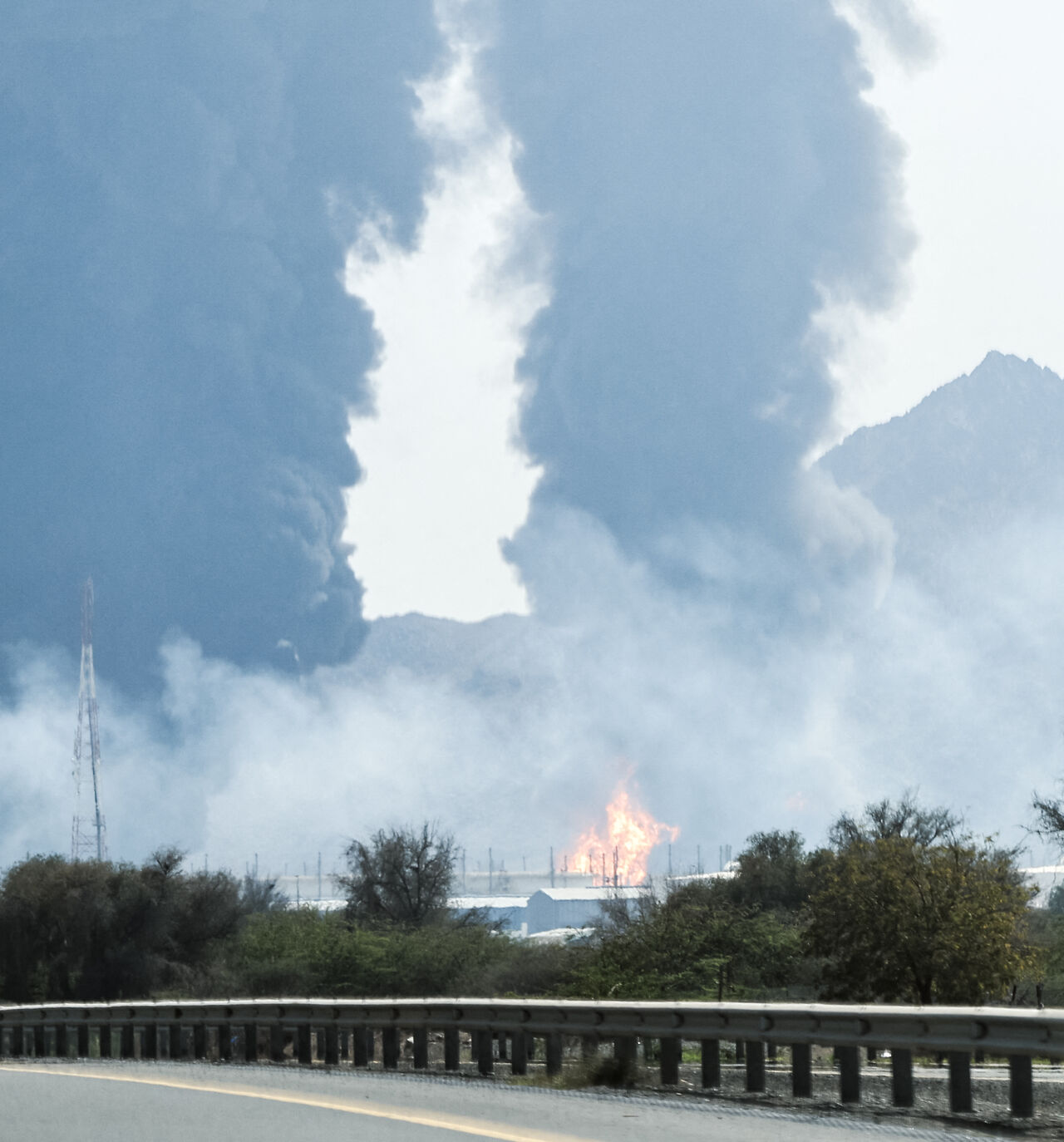 Smoke and flames rise from an energy installation in the Gulf emirate of Fujairah on March 14, 2026. Smoke could be seen rising from the direction of a major UAE energy installation on March 14, in what appeared to be the latest strike targeting the Gulf's petroleum facilities hours after the US struck Iran's Kharg Island. (Photo by AFP via Getty Images) /