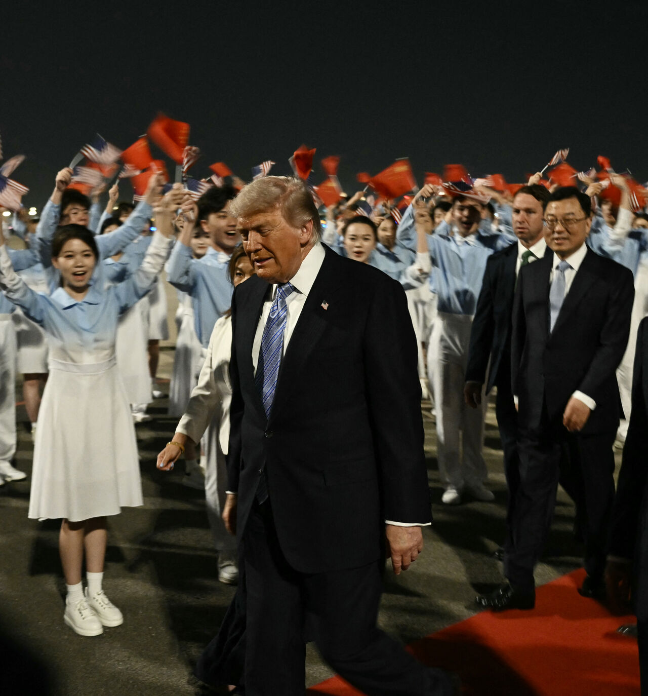 TOPSHOT - US President Donald Trump (C) is escorted by China's Vice President Han Zheng (R) upon his arrival at Beijing Capital Airport in Beijing on May 13, 2026. (Photo by Brendan SMIALOWSKI / AFP via Getty Images)