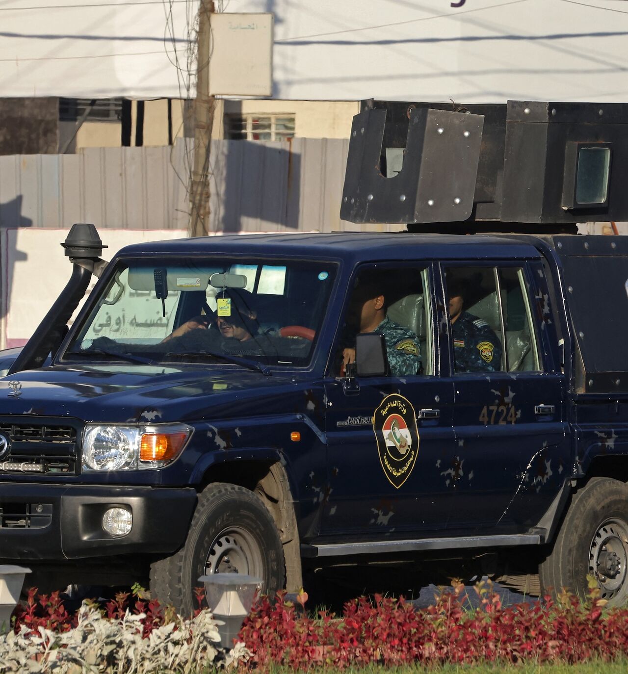 aqi security personnel patrol in a vehicle along a street in Baghdad on June 28, 2026.