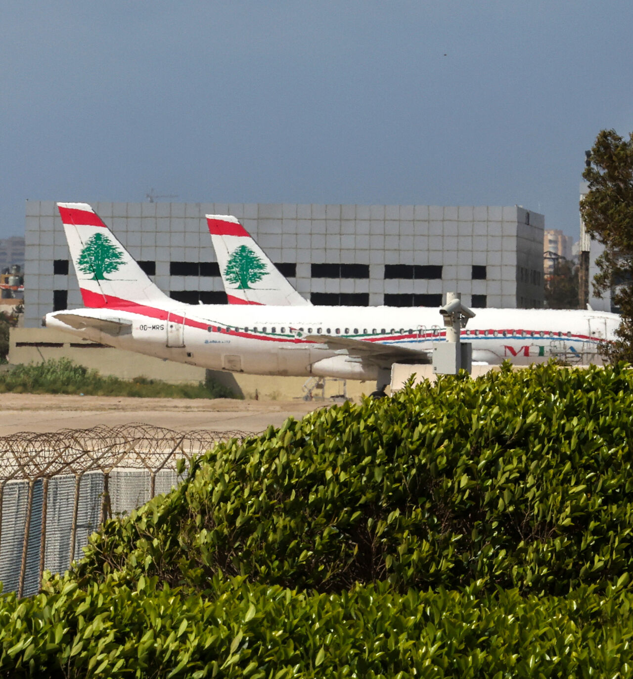 Middle East Airlines aircraft sit on the tarmac at Beirut's Rafik Hariri airport on April 10, 2026. Smoke from an Israeli strike still lingered in the air as a plane from Lebanon's national carrier took off from Beirut airport, which has stayed open despite the latest war between Israel and Hezbollah. The country's only international passenger facility, whose departure boards are now largely red with cancellations, is located on the Mediterranean coast at the edge of Beirut's southern suburbs. (Photo by Anw