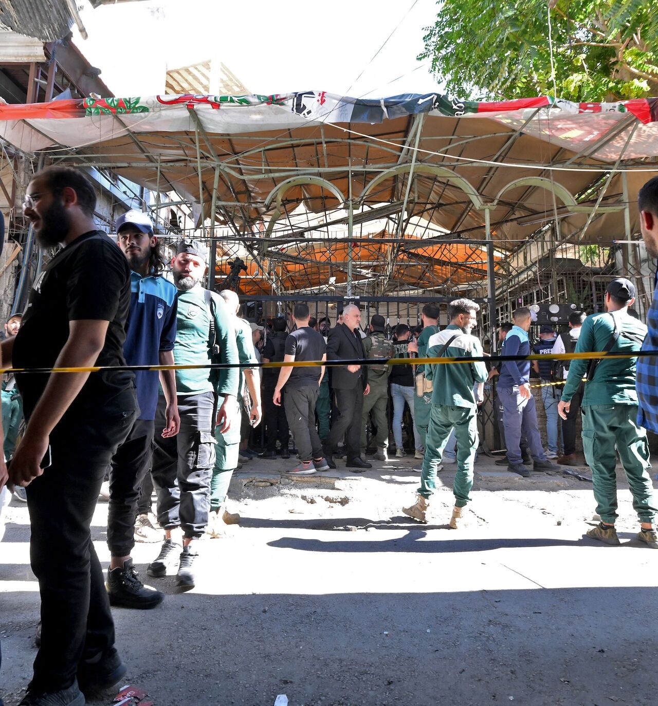Syrian security forces and people gather at the site of an explosion at a cafe in the capital, Damascus, on July 2, 2026. 