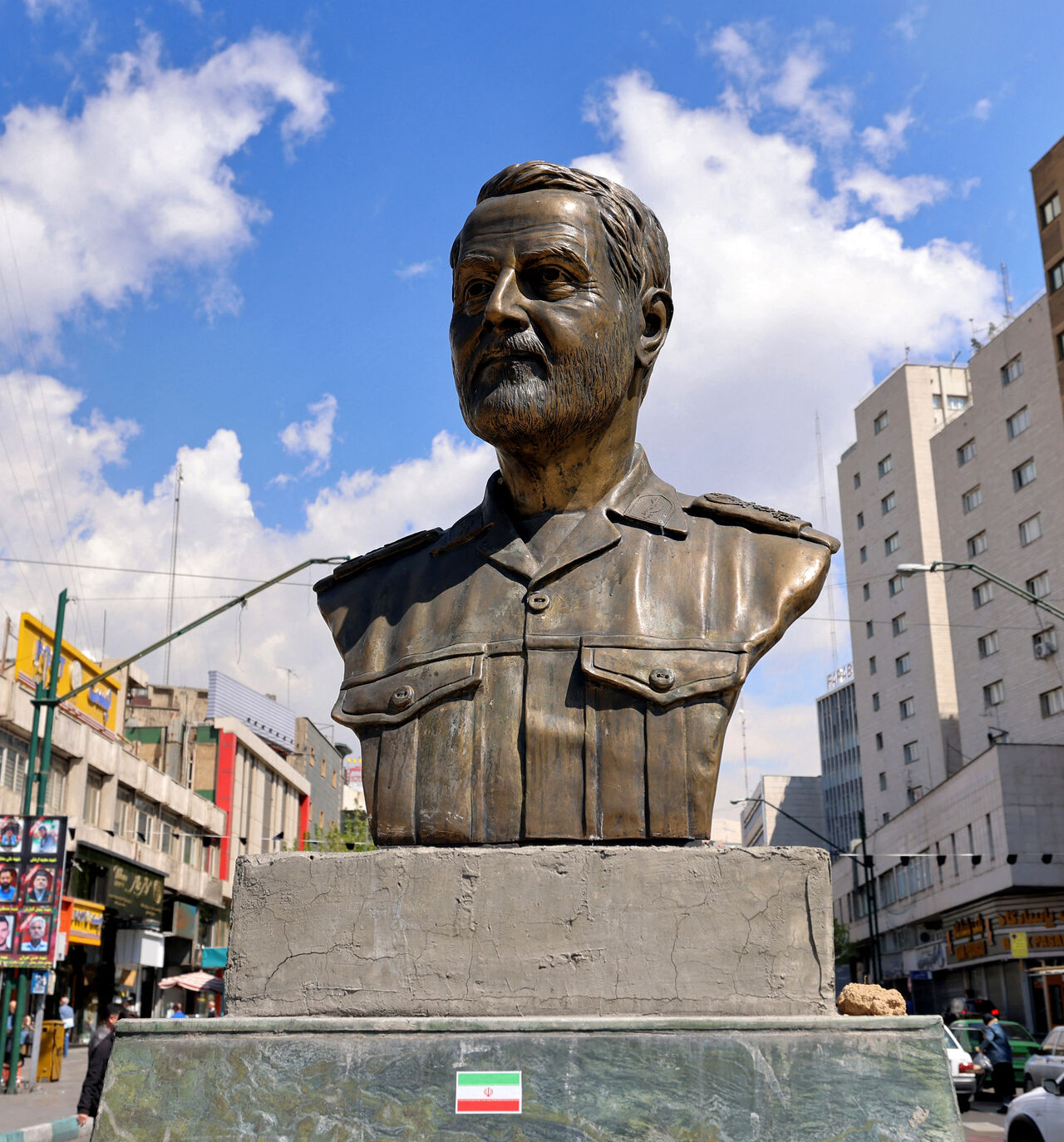 A memorial depicting Qassem Soleimani, the slain commander of the "Quds Force" of Iran's Islamic Revolutionary Guards Corps (IRGC), who was killed by a US airstrike in Iraq in 2020, is pictured at Valiasr Square in Tehran on April 6, 2026. Israeli strikes killed the intelligence chief of Iran's Revolutionary Guards, as the Islamic republic on April 6 defied threats from the US President to devastate civilian infrastructure if it does not reopen the Strait of Hormuz. (Photo by ATTA KENARE / AFP via Getty Ima