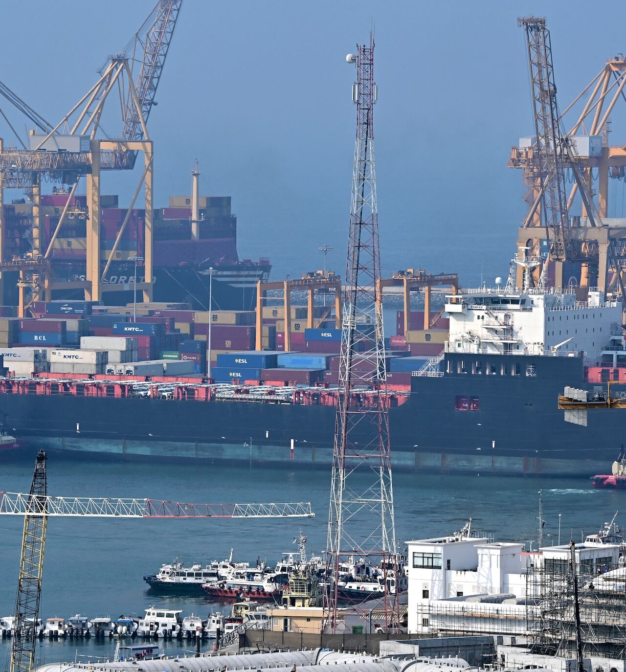 Ships are docked along a pier at the Khor Fakkan Container Terminal, the only natural deep-sea port in the region and one of the major container ports in Sharjah Emirate, along the Gulf of Oman on July 14, 2026. 