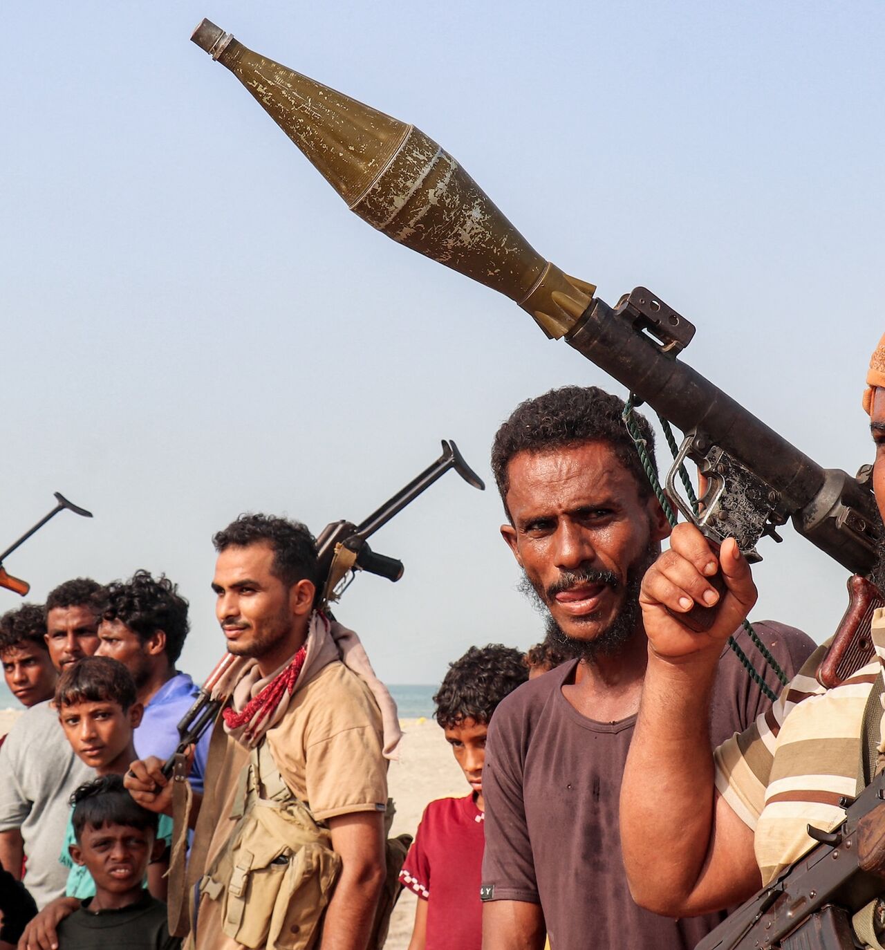 Fighters supporting the Aden-based, internationally recognized Yemeni government gather during a vigil along the Red Sea shore in Khokha, in Yemen's western Hodeidah province, on July 20, 2026. 