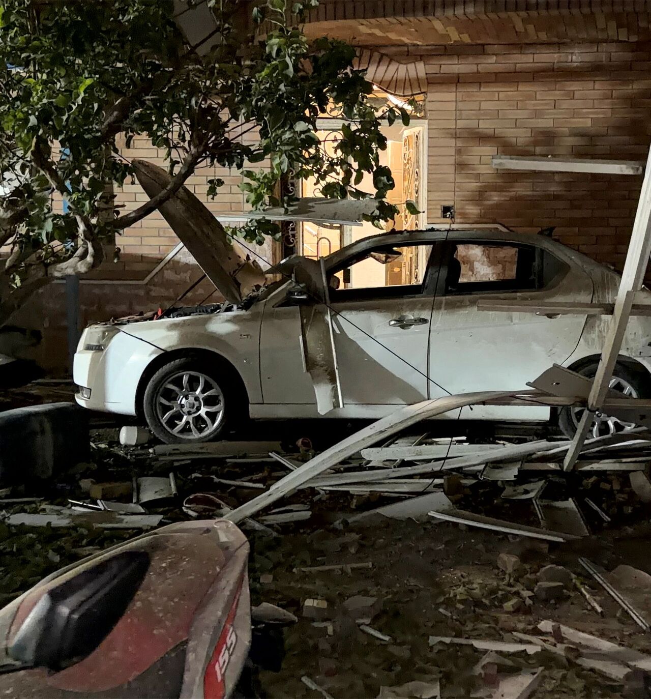 In this picture obtained by AFP from the Iranian news agency Tasnim on September 2, 2026 a destroyed vehicle is pictured at the site of an overnight strike in Kuhestak, Sirik County, in Iran's southern Hormozgan province on September 2, 2026. Iranian forces said on September 2 that they launched attacks on US military targets in the United Arab Emirates, Kuwait, Bahrain and other countries in the region, vowing "severe" consequences for renewed American attacks on the Islamic republic. (Photo by Masoud Moha