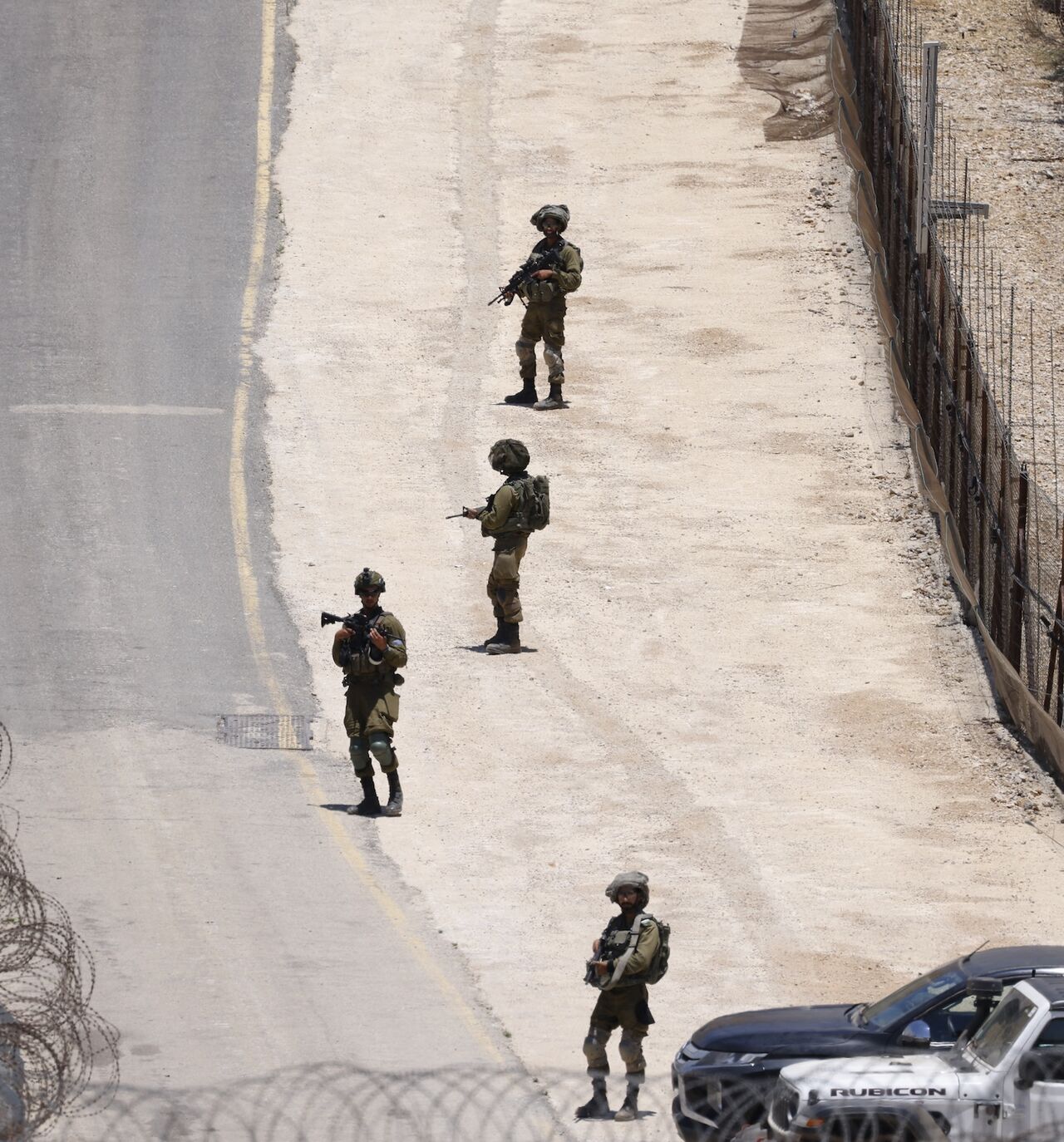 Israeli troops stand guard on the dividing line between the Israeli-annexed Golan Heights and Syrian, near Majdal Shams, July 16, 2025.