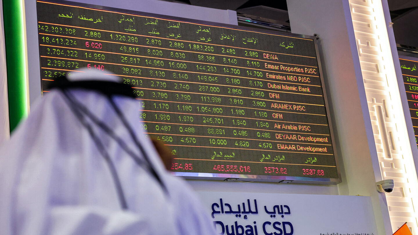 A man watches stock movements on a display at the Dubai Financial Market stock exchange in the Gulf emirate on April 12, 2022. Shares in the Dubai Electricity and Water Authority (DEWA) rose 16 percent on April 12 in the Gulf region's biggest initial public offering since Saudi oil giant Aramco in 2019. (Photo by Giuseppe CACACE / AFP) (Photo by GIUSEPPE CACACE/AFP via Getty Images)